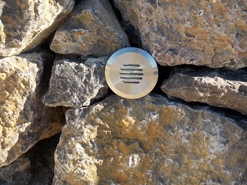 Louvre 316 stainless steel light in stone wall